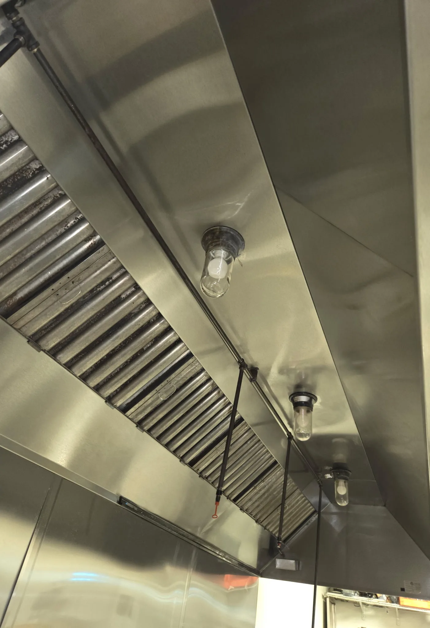 Clean commercial kitchen hood interior showing baffle filters after cleaning in South Jersey